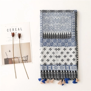 Detailed close-up of a plaid cotton linen scarf with blue and beige tassels