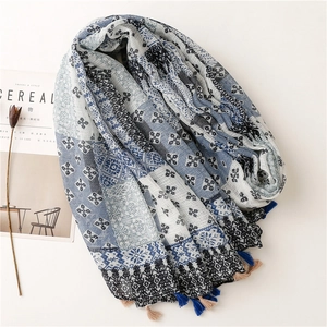 Detailed macro view of geometric cotton linen scarf with soft fringe edges and boho print