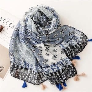 Detail of plaid cotton linen scarf featuring vintage geometric patterns and tassels