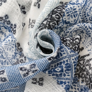 Detailed macro view of lightweight cotton linen scarf with blue floral printed patterns