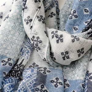 Detail of blue and white ethnic print cotton linen scarf with soft breathable texture