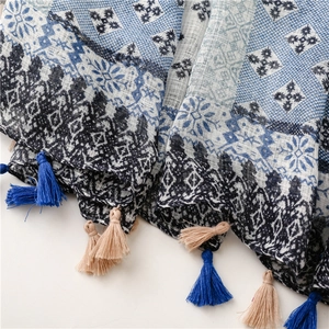 Detail of plaid cotton linen scarf showing bohemian fringe and woven fabric texture