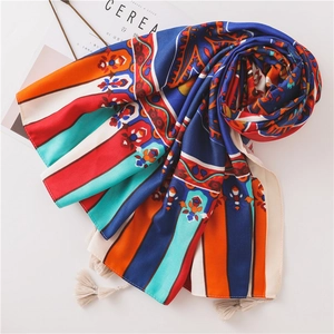 Close-up of bohemian paisley scarf with vibrant floral patterns and beige fringe tassels