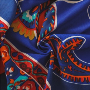 Macro shot of navy blue paisley printed fabric showing soft twill weave texture