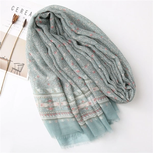 Light blue floral scarf with ethnic patterns and tassels for beach sun protection