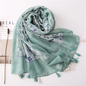 Elegant mint green linen cotton scarf with blue floral prints and tassel fringe details