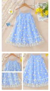 Close-up of blue daisy print dress featuring soft tulle layers and ruffled details