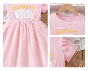 Detail of pink Birthday Girl dress with gold glitter lettering and ruffled mesh skirt
