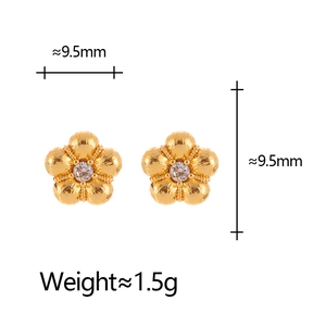 Detail of floral earrings with gold brushed texture and centered cubic zirconia stones