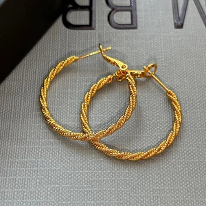 Elegant gold twisted rope hoop earrings with sophisticated spiral texture design for women