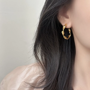 Elegant gold twisted hoop earrings for women featuring a minimalist spiral design