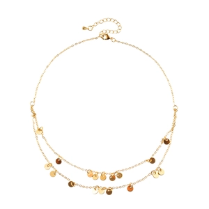 Double-layered gold sequin necklace with delicate round coin pendants on white background