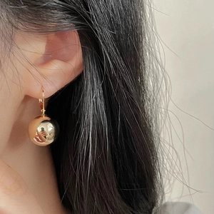 Minimalist gold metal ball drop earrings for women with a polished mirror finish