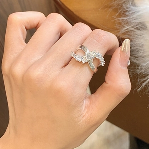 Elegant silver infinity cross ring with pavé zircons and a delicate brushed metal finish