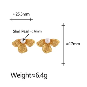 Elegant gold flower stud earrings with white shell pearls in a minimalist design