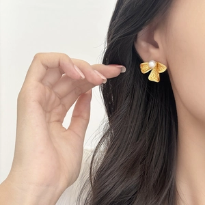 Exquisite gold leaf earrings with white pearls featuring handmade hammer texture finish
