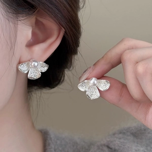 Elegant moth-shaped pearl stud earrings with textured silver wings and white pearls