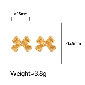 Golden bow-knot stud earrings with textured finish and cubic zirconia showing measurements