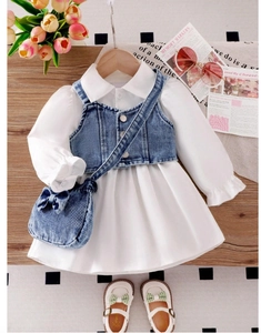 Detail of girls' white puff sleeve shirt dress with denim vest and matching bow bag