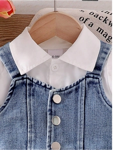Detail of white puff sleeve shirt collar and denim vest texture for baby girl set