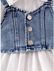 Close-up of denim vest with metal buttons and white shirt collar for girls' outfit