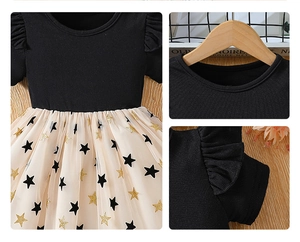 Detail of girls' dress featuring black ribbed knit top and beige star sequin tulle skirt