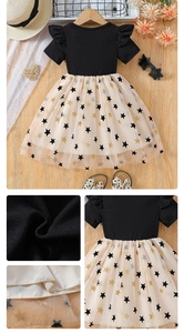 Detail showing girls' ribbed knit top with ruffled sleeves and star pattern mesh skirt