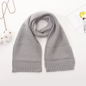 Close-up of light gray chunky knit baby scarf with soft wavy texture for winter