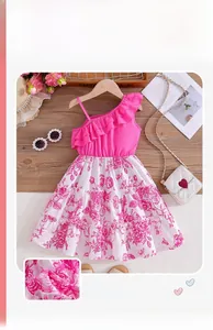 Detail of pink one-shoulder girl's dress with ruffled bodice and floral mesh skirt layers