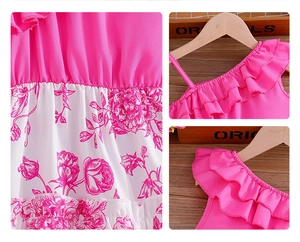 Close-up of rose flower print and ruffle details on girl's summer strap dress