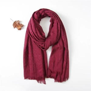 Burgundy linen-feel scarf with white polka dots and frayed fringe on a white background