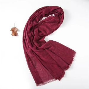Burgundy linen scarf with white polka dots and fringed edges on a clean white background
