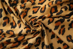 Detailed close-up of leopard print scarf fabric showing soft twill weave texture