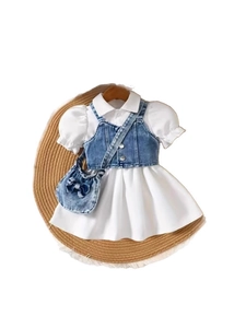 Girls white puff sleeve dress with denim vest and matching bow bag on straw mat