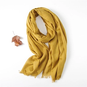 Mustard yellow cotton linen scarf detail with rhinestones and fringe edges on white background