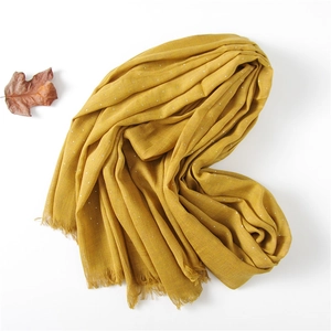 Detail of mustard yellow linen scarf with silver polka dots and autumn leaf decor