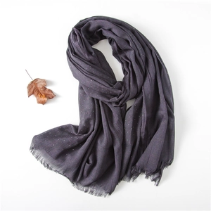 Close-up of dark purple cotton scarf with white rhinestones and fringe edges