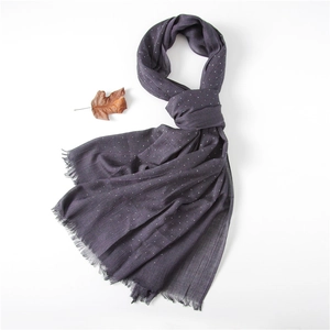 Close-up of deep purple cotton linen scarf with white polka dots and frayed edge details