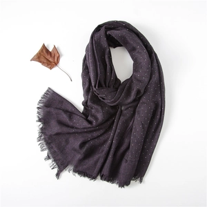 Detail of plum purple cotton linen scarf with white polka dots and frayed fringe edges
