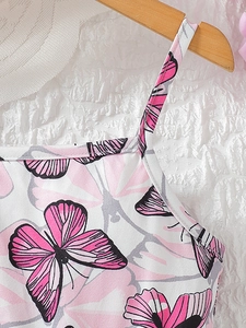 Girls summer strap dress with vibrant pink butterfly prints on white fabric