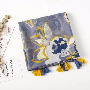 Detail of floral cotton linen scarf with abstract prints and handmade tassel edges