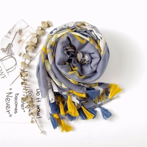 Abstract geometric pattern cotton linen scarf with colorful tassels in a spiral flat lay