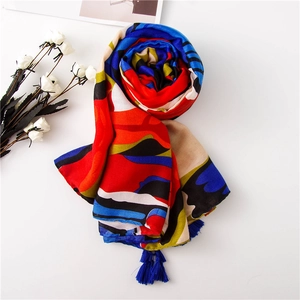 Abstract vibrant oil painting style linen scarf with tassels in flat lay arrangement