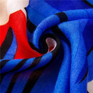 Macro shot of vibrant geometric pattern on light cotton linen scarf with soft draping detail