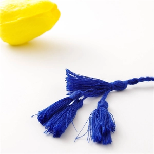 Close-up of deep blue multi-layered bohemian tassels with intricate braided knots
