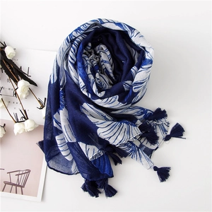 Deep blue cotton linen scarf with white floral print and tassel edges on white background