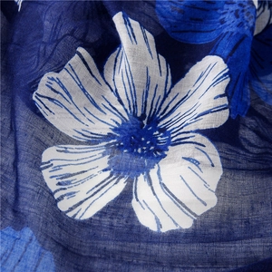 Close-up of blue floral print scarf showing delicate cotton linen texture and weave