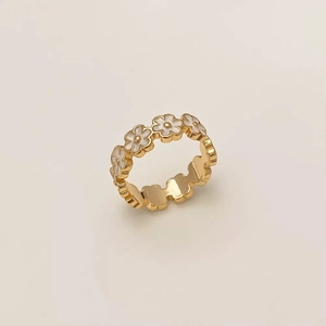 Minimalist gold ring featuring elegant white enamel flowers with a polished metal finish