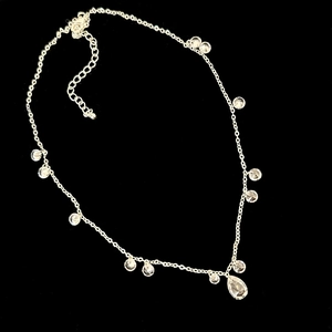 Detail of silver drop zircon necklace featuring a pear-shaped pendant and adjustable chain