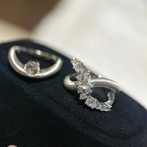 Elegant matte silver rings with sparkling zircon stones on a black velvet background